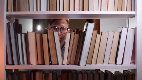 Librarian Searching Bookshelf Looking for Book in Library