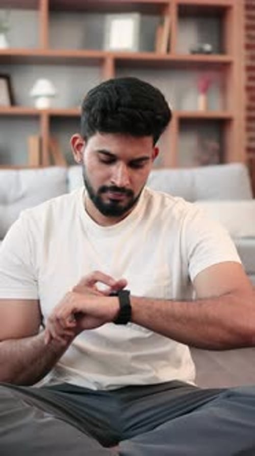Man Checks Smartwatch After Workout