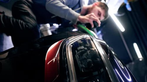 Vertical Video the Car Mechanic at a Service Station Doing the Final Polishing to Shine