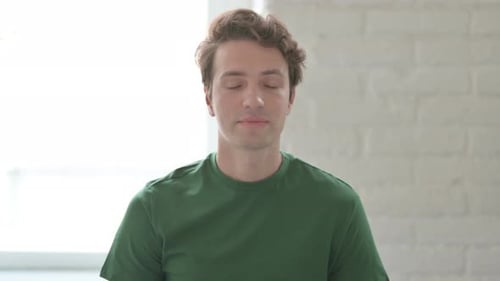 Adult Man Speaking Indoors, Wearing Green Shirt