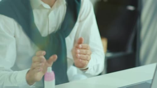 Close Up Hands Young Man Disinfects Hands with Antiseptic Before Working on Laptop Workplace