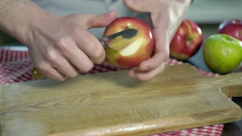 Apple peeling on a wooden cutting board