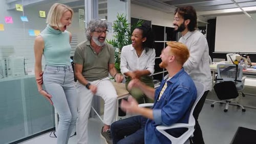 Enthusiastic Team Celebrates Victory in Modern Office