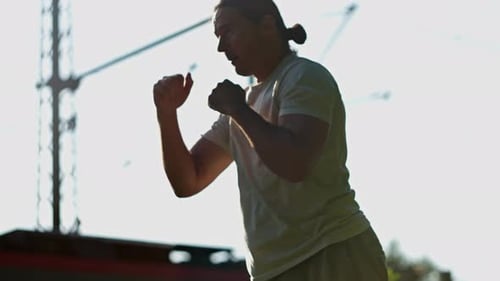 A Dynamic Fighter Engages in an Intense Training Session During the Beautiful Sunset Hour Slow