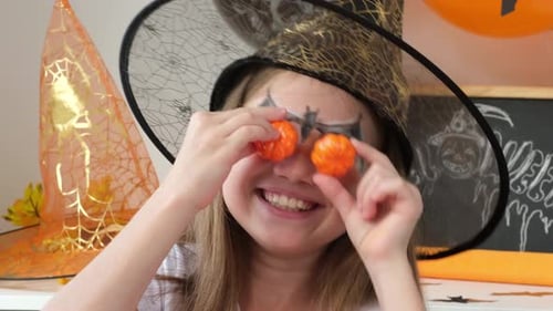 Girl Celebrates Halloween with Pumpkin Decorations