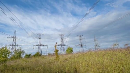 Power plant timelapse electricity - High-voltage support with clouds in the sky