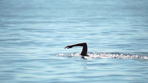 Woman Swims in Crystal Clear Sea Water Enjoys Summer