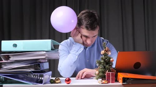Office Worker Bored at Work During Christmas Time
