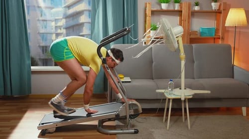 Man Working Out on Treadmill Inside Apartment