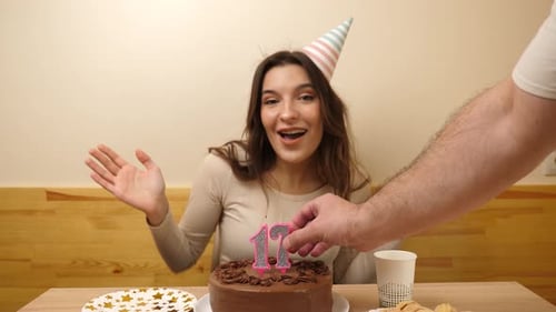 Young Woman Celebrates Birthday with Cake and Candles