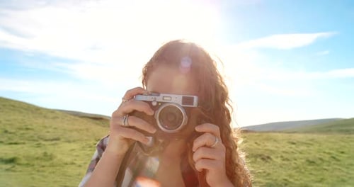 Woman Taking Pictures with a Vintage Camera Outdoors