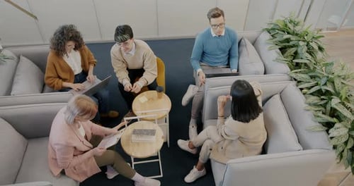 High Angle View of Businesspeople Creative Team Discussing Ideas in Modern Office