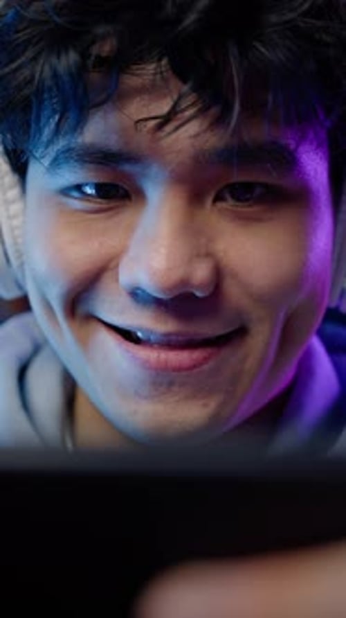 Excited Young Man Gaming on Mobile Phone