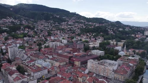 Aerial of Sarajevo showcasing the Church of Saint Anthony and surrounding mountains