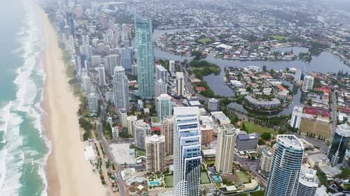 4k drone footage of a coastline alongside a city