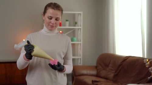 Woman Styles Dessert at Home with Piping Bag