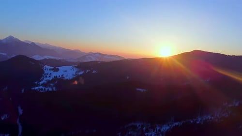 Aerial view of the mountain winter landscape at sunset