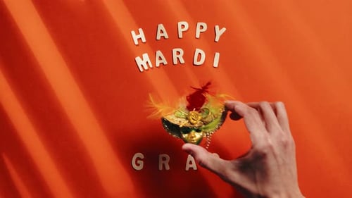 Mardi Gras Mask Placed on Orange Surface