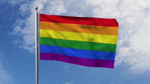 Waving Rainbow Pride Flag Against Blue Sky