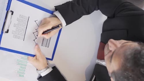 Businessman Analyzing an Upward Trending Line Graph