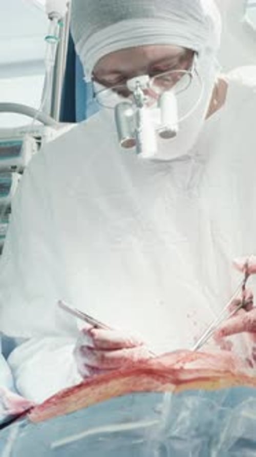 Surgeon Using Tools During Operation in Hospital Room