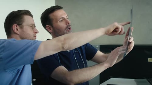 Two Doctors Analyzing X-Ray in Office Setting