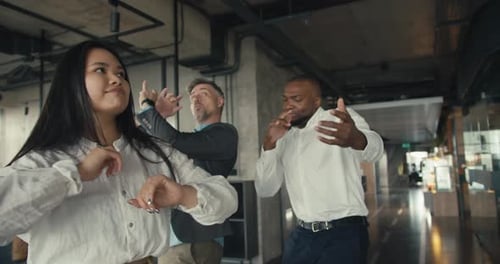 Multiracial Company in the Office Dancing in Honor of a Successful Cause Happy People in the Office