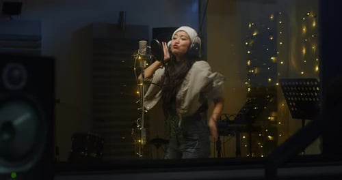 Young Woman Singing Christmas Song in Recording Studio
