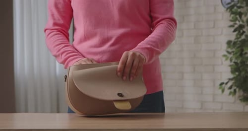 Woman Opens Beige Fashion Bag