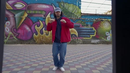 Street Dancer Dances a Modern Hip Hop Dance in a Red Jacket