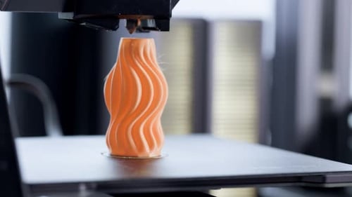 3D Printer, 3D Printing orange object. 4.0 industrial revolution. Extreme Close Up.