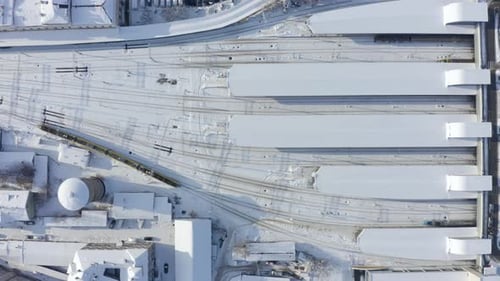 Aerial view around a train in winter. Drone view of trains at the railway station