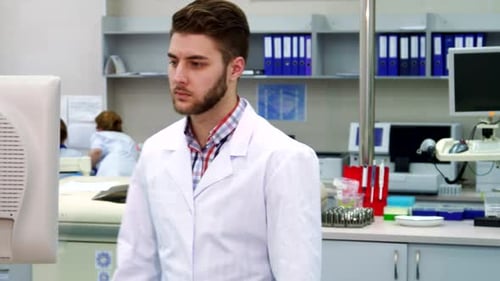 Scientist Working on Computer in Bright Lab