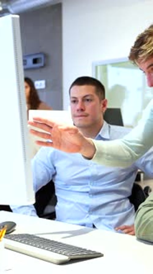 Office Workers Collaborating on Computer Project