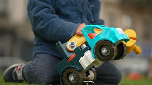 Young Kid Engrossed in Excavator Play at Park - Child with Toy Claw in Autumn Season