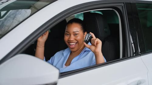 Happy Customer Showing New Car Key While Sitting Inside