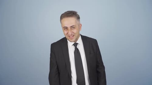 Confident Man in Suit Posing in Studio