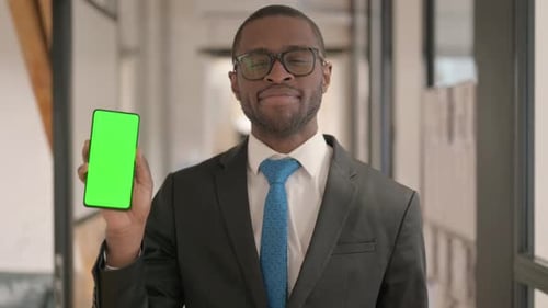 Portrait of African Businessman Holding Phone with Green Screen