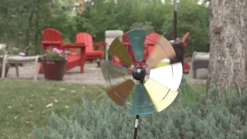 Whimsical Wind Spinner Rotating in a Backyard Setting
