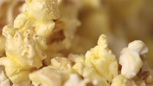 Cinema Popcorn Background. Ready Popcorn Flakes Falling Into Heap In