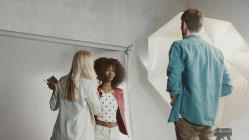 Backstage of the Photo Shoot: Make-up Artist Applies Makeup on Beautiful Black Model, in a Moment P
