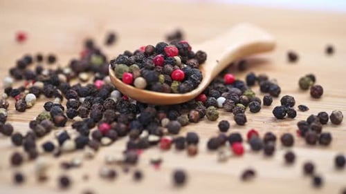 Close Up of Assorted Peppercorns in Wooden Spoon for Cooking