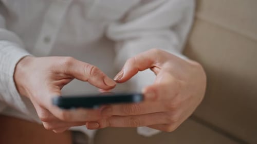 Woman's hands using smartphone in close up shot