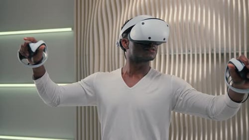 Man Using Virtual Reality Headset with Controllers