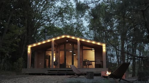 Rustic Cabin in Forest at Night With Firepit