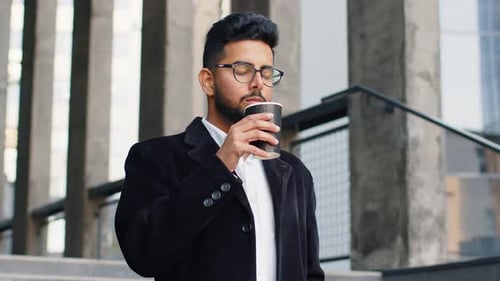 Happy Indian Business Man Enjoying Morning Coffee Hot Drink Relaxing Taking a Break in Downtown City