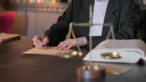 Close Up of Judge Writing Verdict in Court