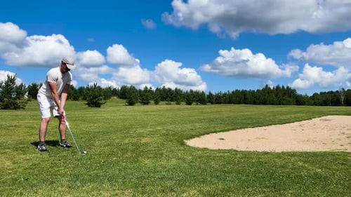 Male enjoy golf game on green course, cloudy summer sky in Latvia