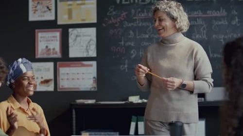 Teacher Explains Lesson to Diverse Students in Classroom