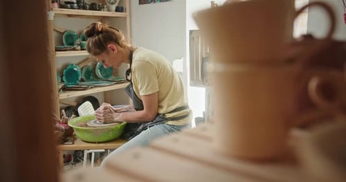 Female Potter Working in Studio